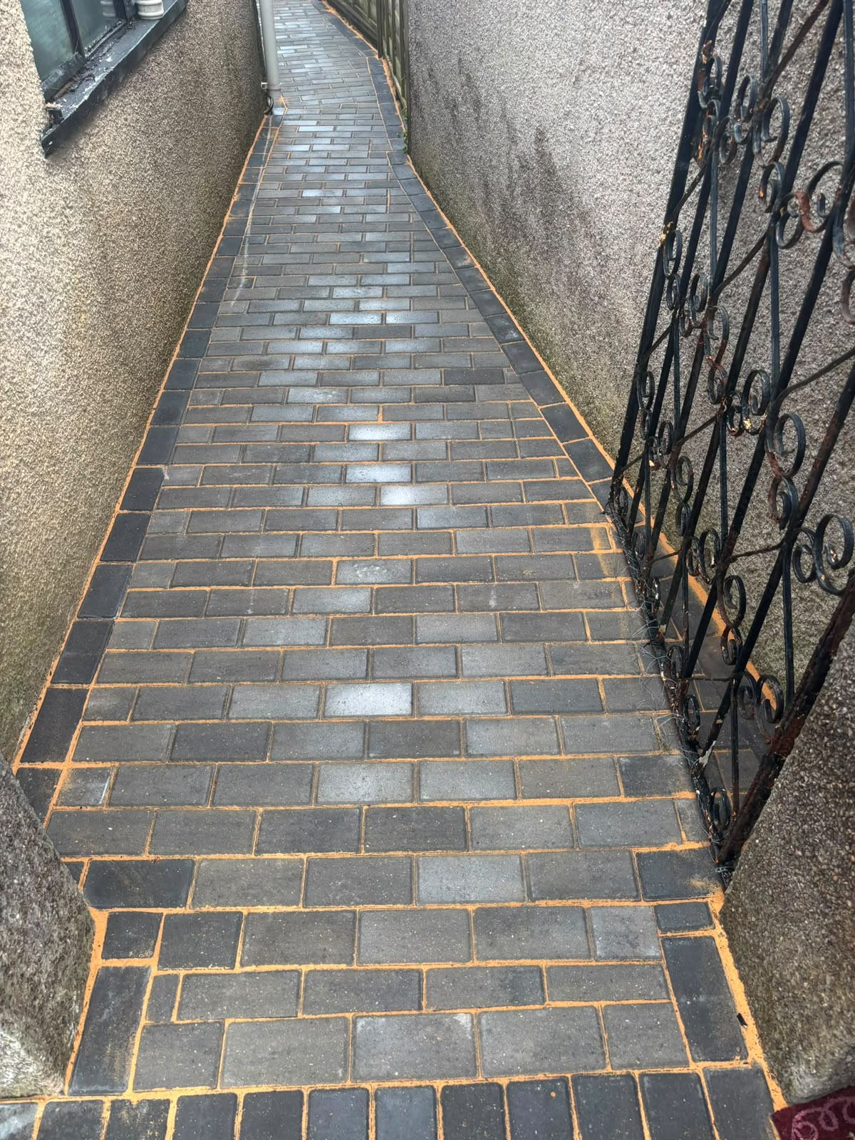 Grey block-paved side path