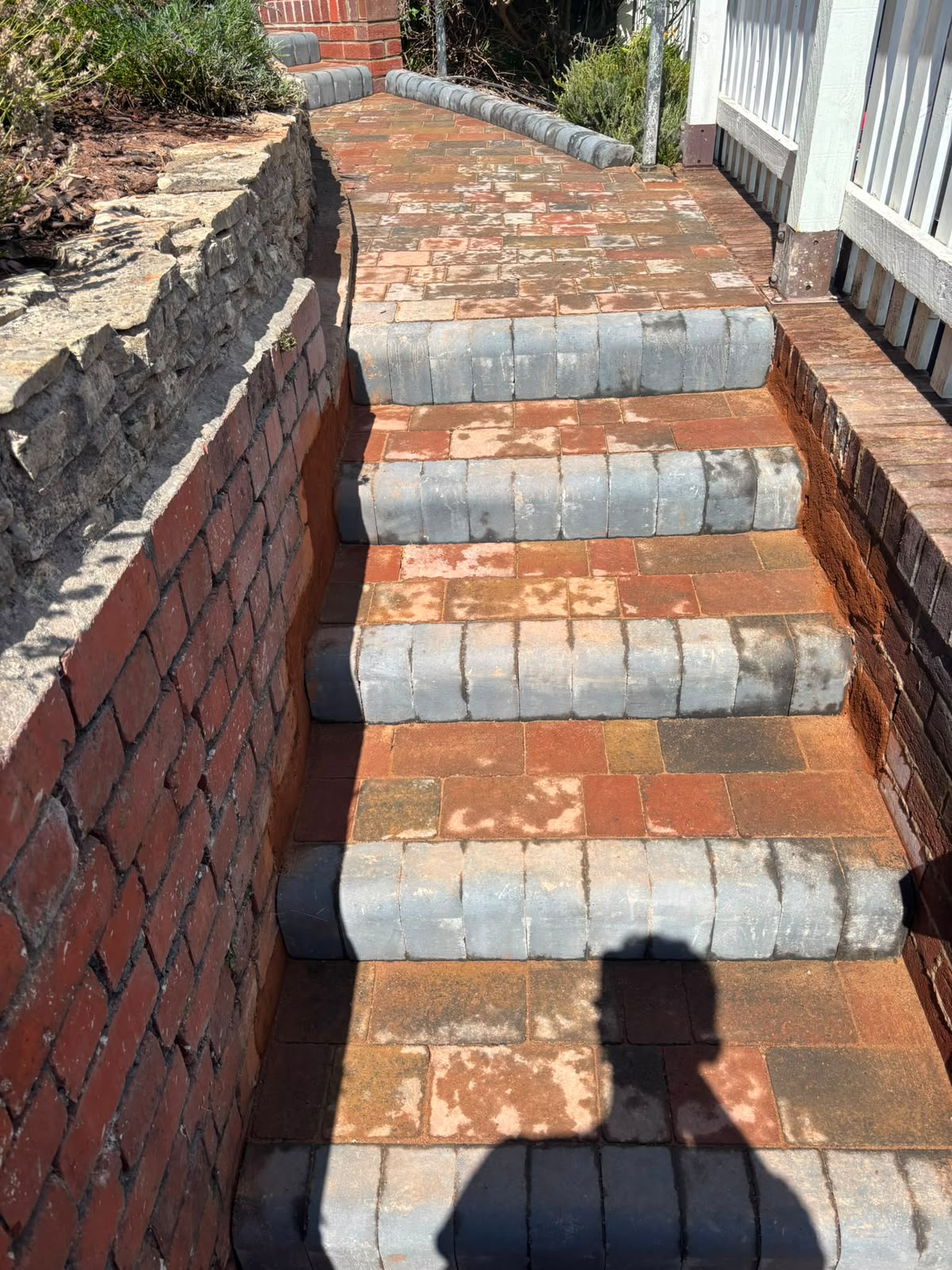 Brick retaining wall beside block-paved garden steps