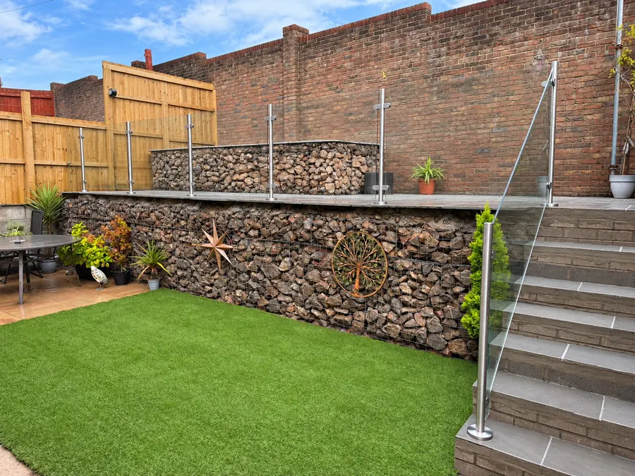 Artificial lawn, gabion retaining wall, paved steps and timber fence