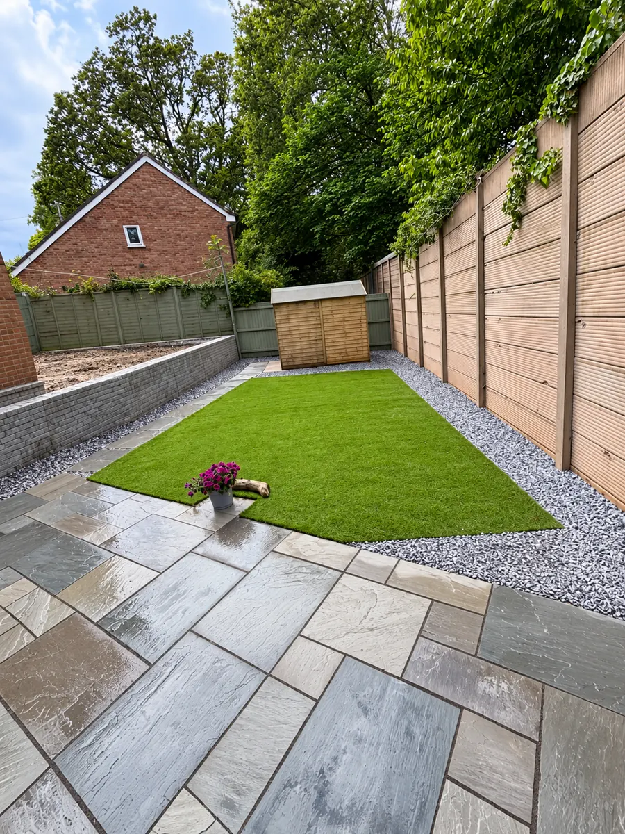 Sandstone patio, artificial lawn and gravel border in long garden