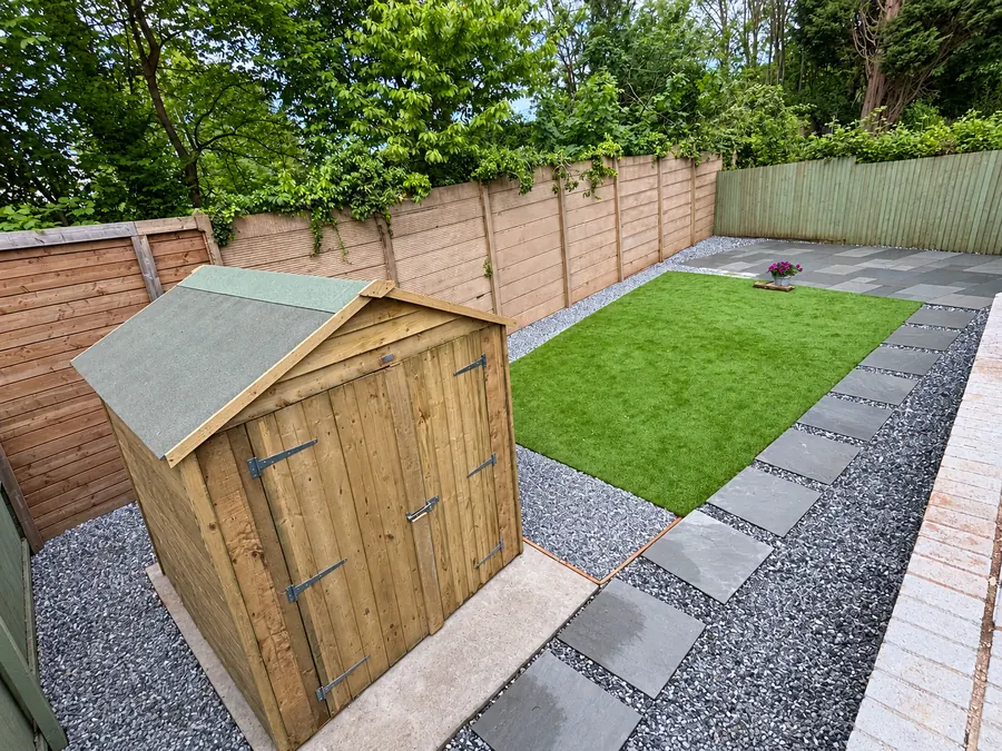 Artificial lawn, gravel border and slab stepping-stone path by shed