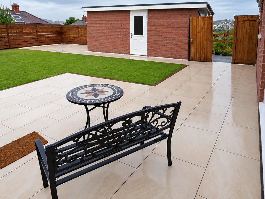 Pale slab patio, artificial lawn and timber garden boundary