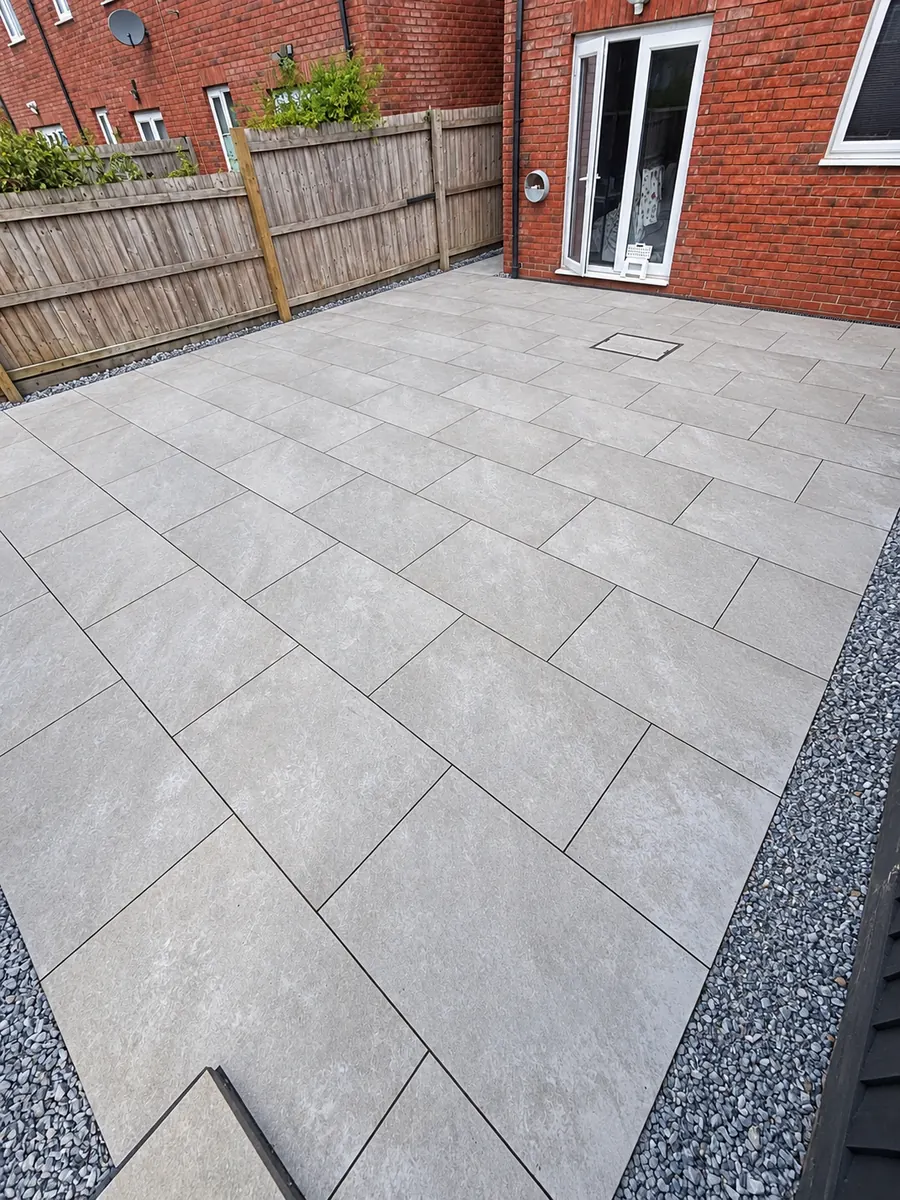 Finished grey slab patio outside townhouse