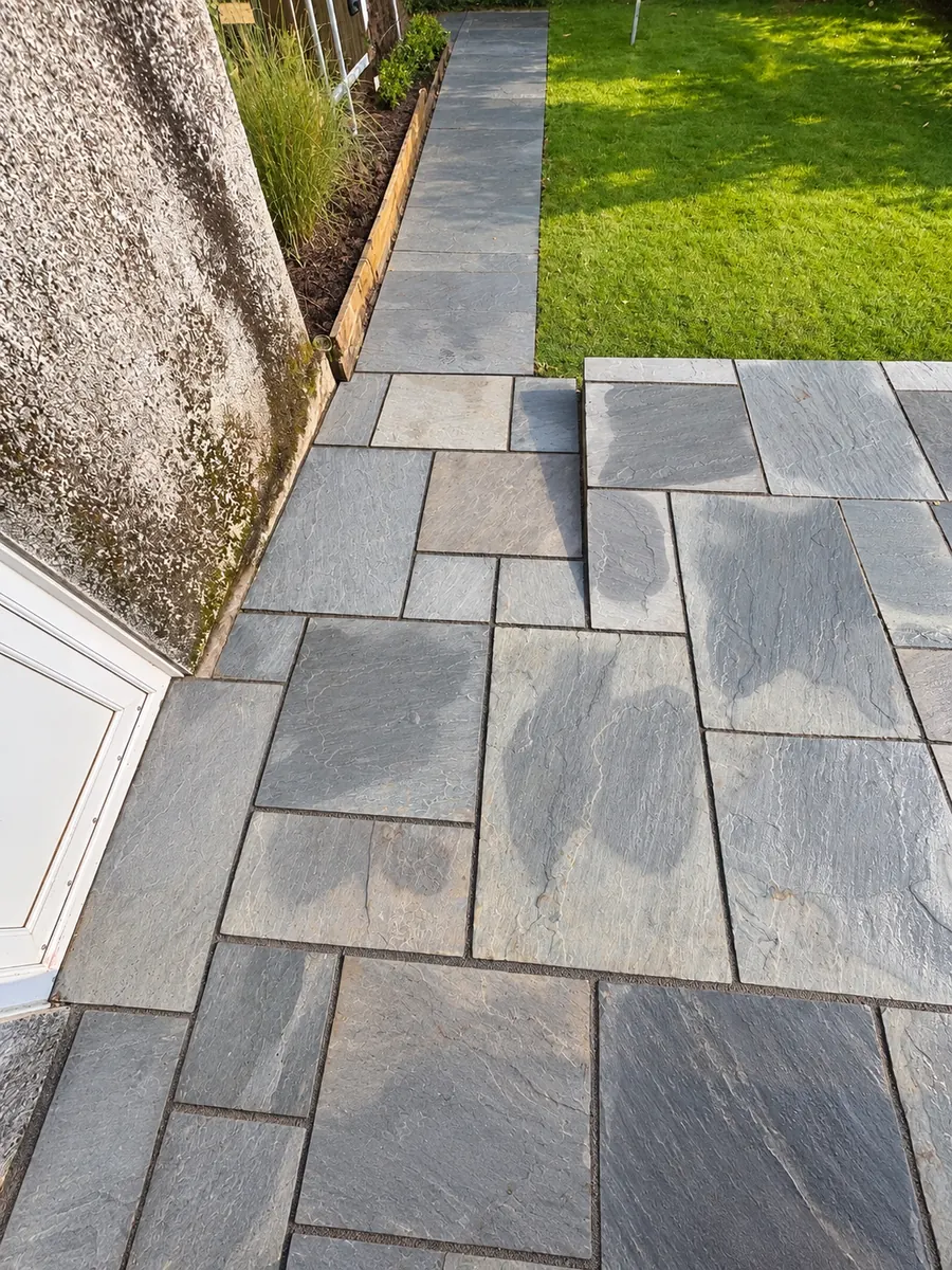 Stone slab path along established lawn
