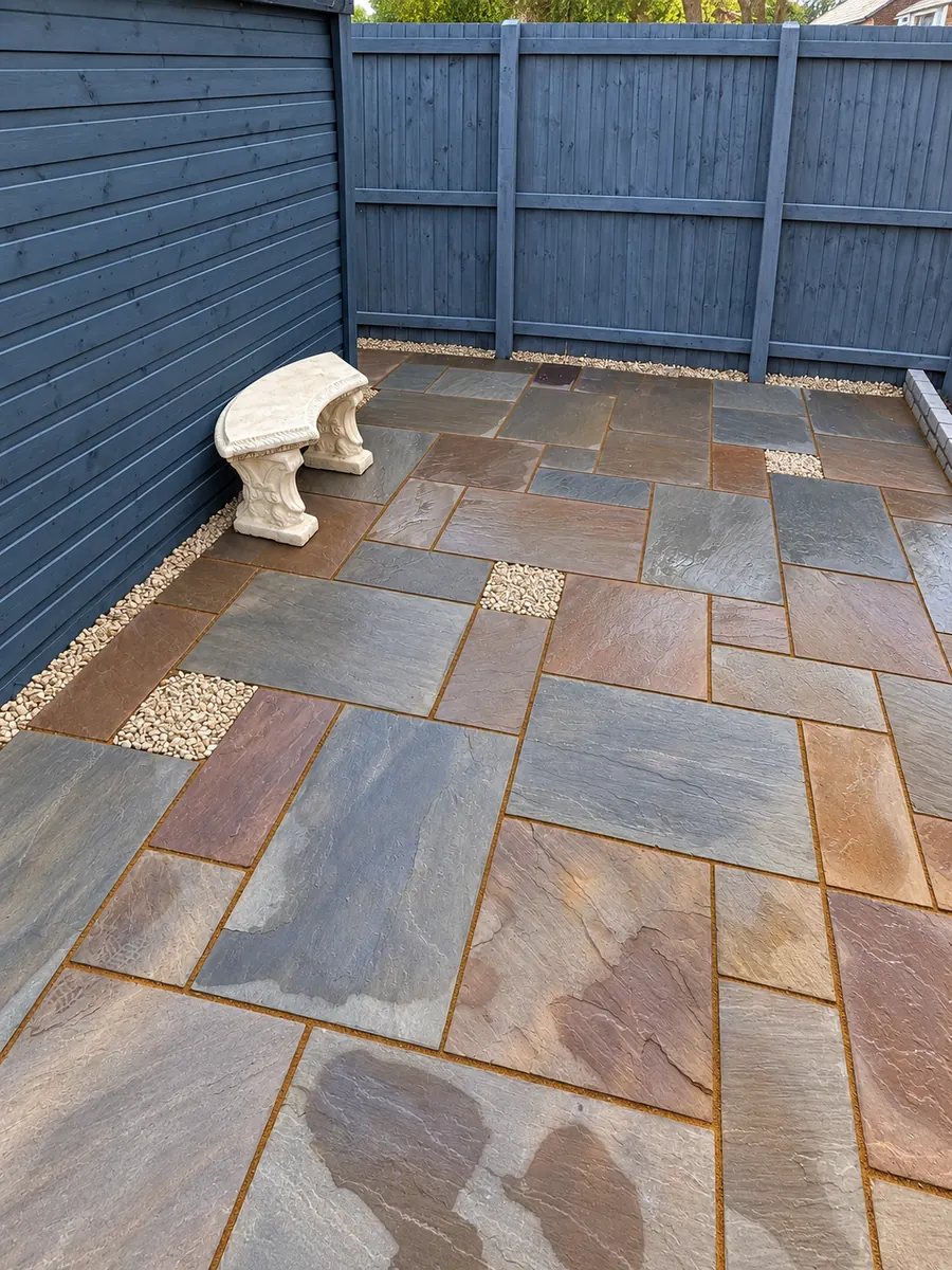 Sandstone patio with blue timber fencing and stone bench