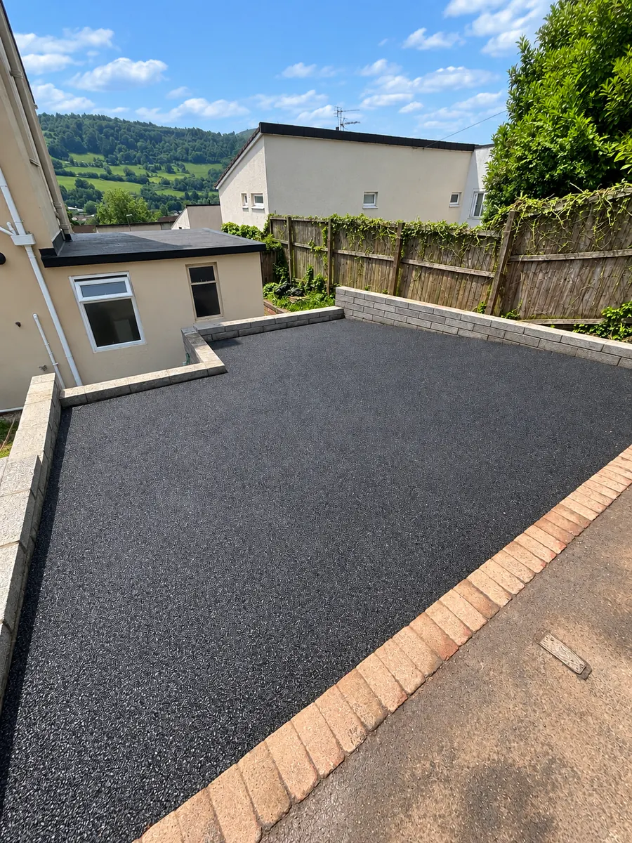 Finished black tarmac driveway with contrasting block edging