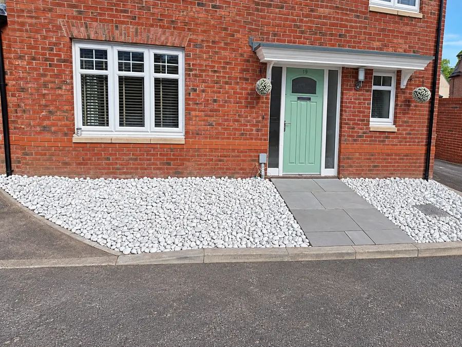 White gravel front garden with grey slab entrance path