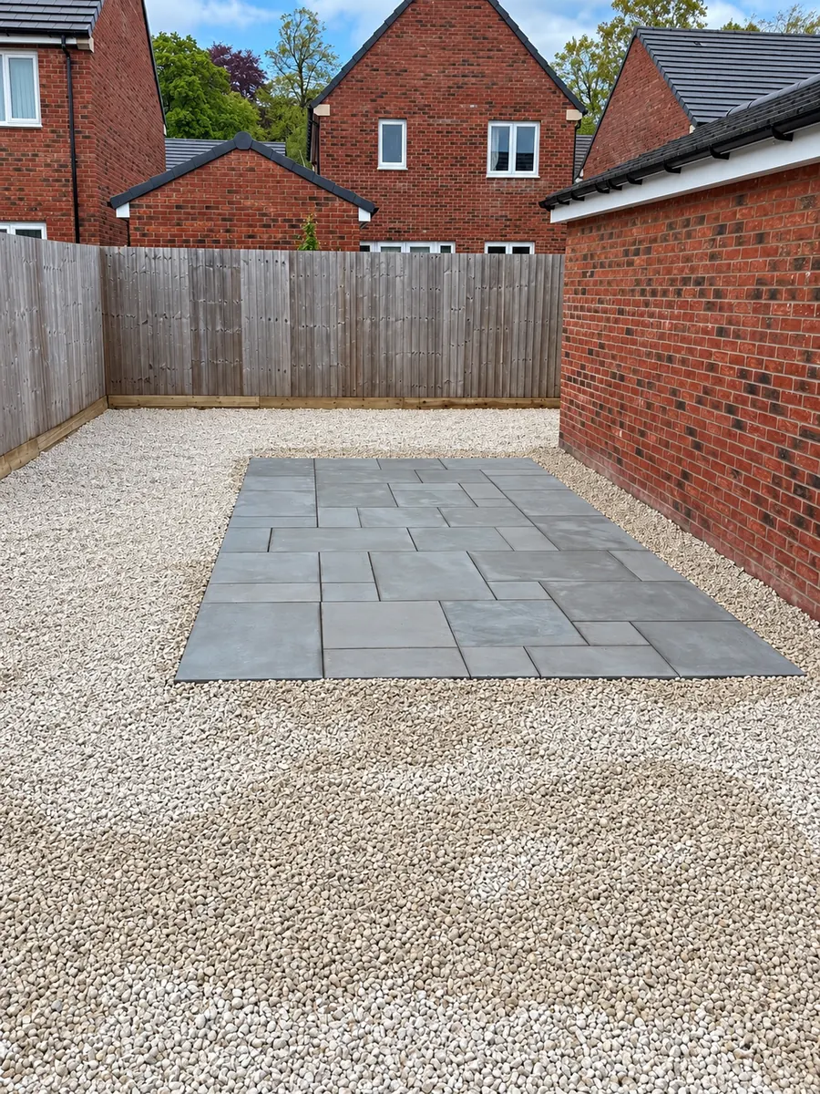 Grey slab patio surrounded by loose gravel