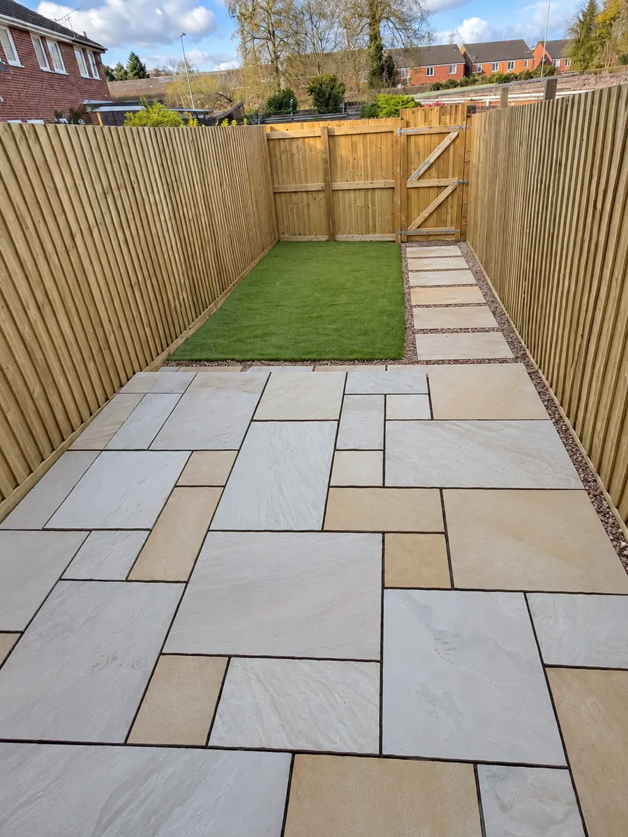 Narrow sandstone patio, artificial lawn and timber fencing, alternate view