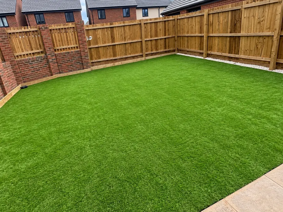 Artificial lawn enclosed by timber fencing